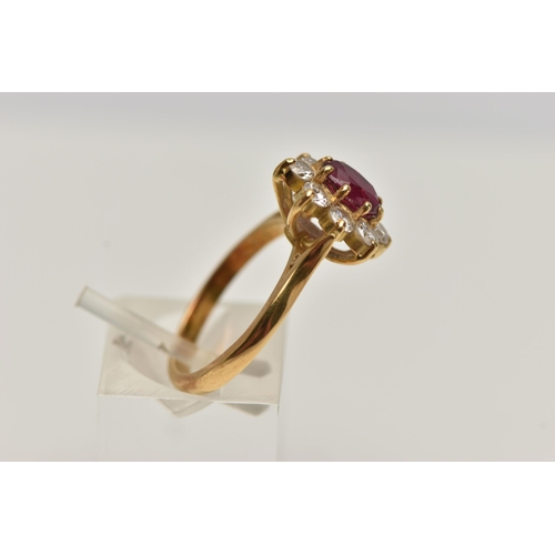 3 - A MODERN RUBY AND DIAMOND CLUSTER RING, a principle oval cut ruby, approximate length 7mm x width 5.... 