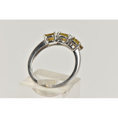 63 - A 9CT WHITE GOLD GEM SET RING, designed with three claw set, square cut citrines, interspaced with c... 