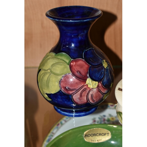 384 - THREE PIECES OF MOORCROFT POTTERY, comprising a Magnolia pattern covered pot, a Clematis vase height... 