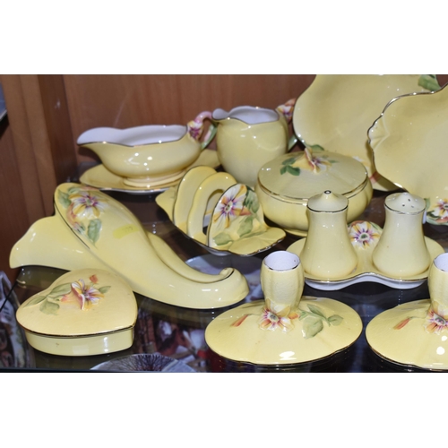 399 - A LARGE QUANTITY OF ROYAL WINTON YELLOW  'PETUNIA' PATTERN TABLEWARE, comprising a square cake plate... 