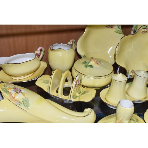 399 - A LARGE QUANTITY OF ROYAL WINTON YELLOW  'PETUNIA' PATTERN TABLEWARE, comprising a square cake plate... 