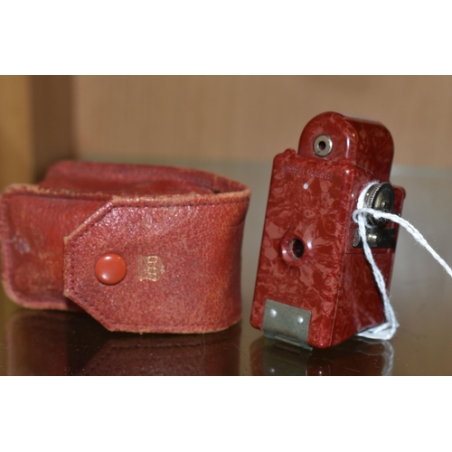 429 - A RED BAKELITE CORONET MIDGET  POCKET CAMERA, made by the Coronet Camera Co. Birmingham, with origin... 