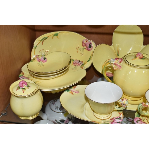 433 - A QUANTITY OF ROYAL WINTON  YELLOW 'PETUNIA' DESIGN TEA WARE, comprising two tennis sets (one cup so... 