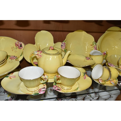 433 - A QUANTITY OF ROYAL WINTON  YELLOW 'PETUNIA' DESIGN TEA WARE, comprising two tennis sets (one cup so... 