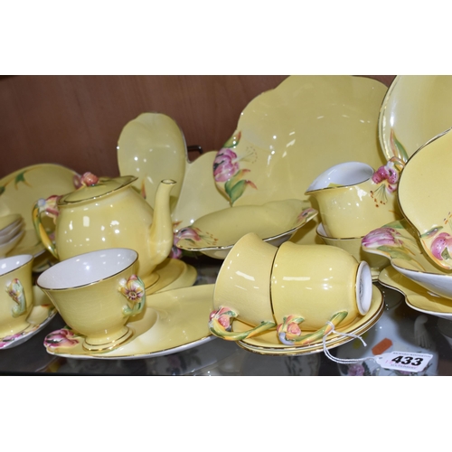 433 - A QUANTITY OF ROYAL WINTON  YELLOW 'PETUNIA' DESIGN TEA WARE, comprising two tennis sets (one cup so... 