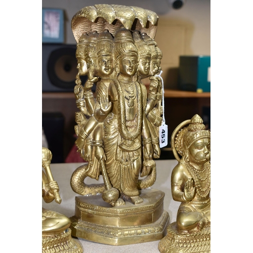 453 - THREE GILT METAL RELIGIOUS HINDU FIGURES, comprising two Lord Hanuman figures, height 17cm, together... 