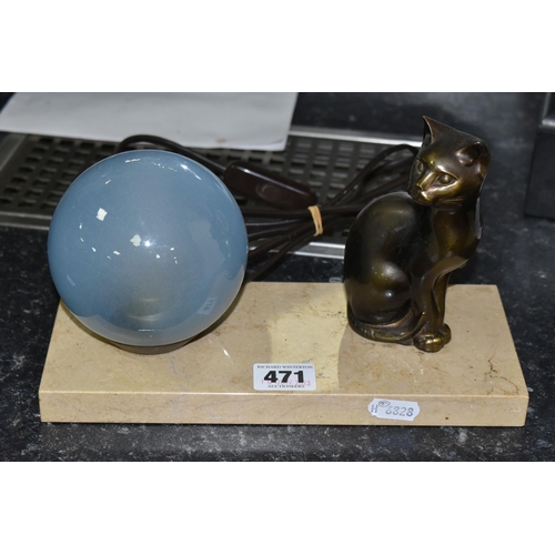 471 - A FRENCH ART DECO TABLE LAMP, featuring a seated cat figure and a blue glass globe shade on a stone ... 