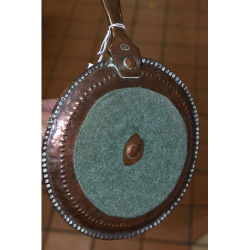 476 - A NEWLYN SCHOOL HAND HAMMERED COPPER CIRCULAR CHAMBERSTICK, stamped on the handle J.P (John Pearson ... 