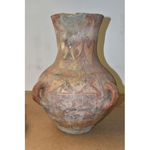 516 - A PAINTED TERRACOTTA FOUR HANDLED URN, POSSIBLY CHINESE OF NEOLITHIC STYLE, decorated with geometric... 