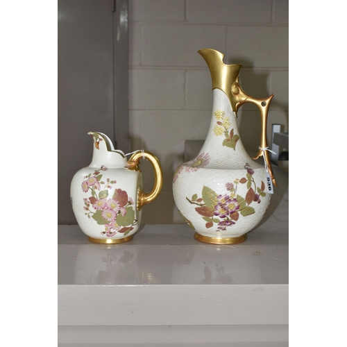 536 - TWO ROYAL WORCESTER IVORY GROUND EWERS, both printed and painted with sprays of flowers, the taller ... 