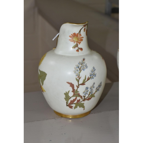 536 - TWO ROYAL WORCESTER IVORY GROUND EWERS, both printed and painted with sprays of flowers, the taller ... 