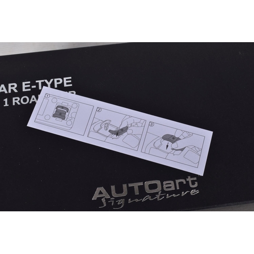 52 - A BOXED AUTOART SIGNATURE JAGUAR E-TYPE SERIES 1 ROADSTER 1:18 MODEL VEHICLE, numbered 73602, serial... 