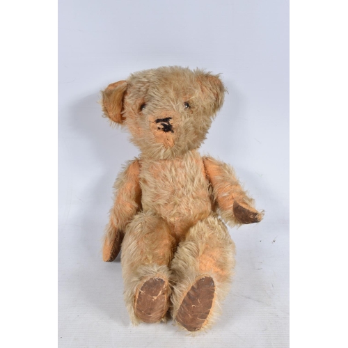 115 - A WELL LOVED GOLDEN PLUSH TEDDY BEAR, original amber and black plastic eyes, remains of vertical sti... 