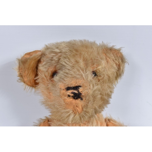 115 - A WELL LOVED GOLDEN PLUSH TEDDY BEAR, original amber and black plastic eyes, remains of vertical sti... 