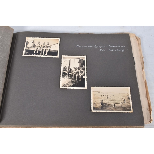 211 - TWO 1936 BERLIN OLYMPIC ALBUMS OF PHOTOGRAPHS, ticket stubs, stamped postcards, the first album cont... 