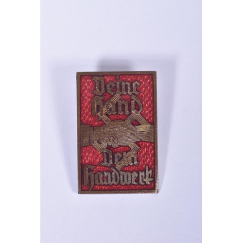 215 - TWO GERMAN ENAMEL PIN BADGES., to include a Diene Hand Dem handwork pin badge, this is red and gold ... 