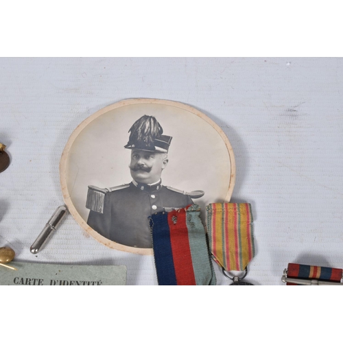 221 - A SELECTION OF BRITISH AND FRENCH MILITARY RELATED ITEMS, to include, three WWII medals, safe drivin... 