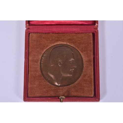 241 - TWO GERMAN ADOLF HITLER PLAQUES, the first is round and comes in a fitted red case and features a po... 