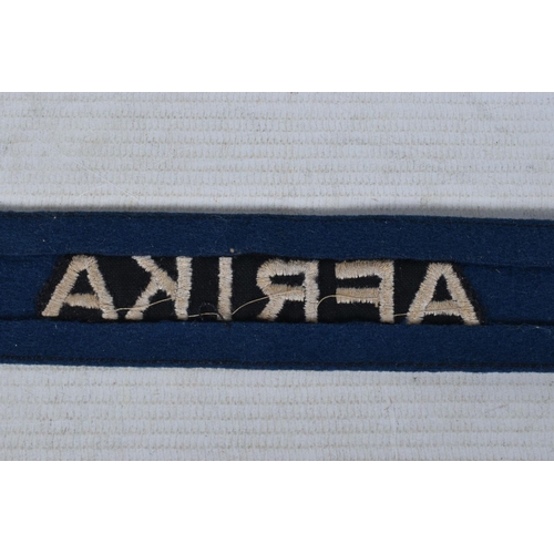 243 - A GERMAN THIRD REICH LUFTWAFFE AFRIKA CUFF TITLE, this a blue with machine embroidered letters, it m... 