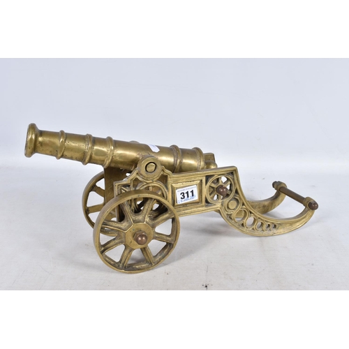 311 - A SELECTION OF MILITARY RELATED ITEMS, to include four  brass cannons, the sticks and two shell case... 