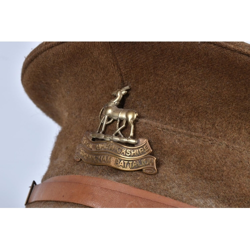 317 - A SELECTION OF WWII ERA AND LATER MILITARY HATS, this lot includes a steel helmet dated 1940 with ne... 