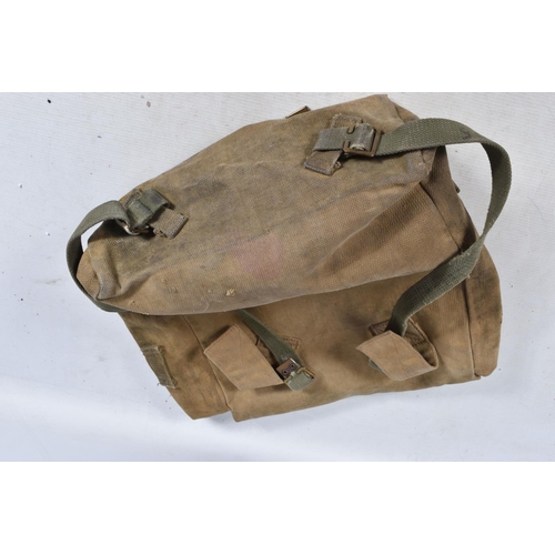 318 - A QUANTITY OF MILITARY RELATED ITEMS, to include bags, gas mask, entrenching tool and a pressure Gua... 