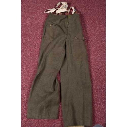 323 - EIGHT ITEMS OF MILITARY CLOTHING, to include WWII dated trousers, this lot includes a pair of 1943 s... 