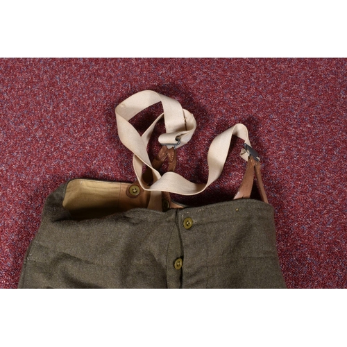 323 - EIGHT ITEMS OF MILITARY CLOTHING, to include WWII dated trousers, this lot includes a pair of 1943 s... 