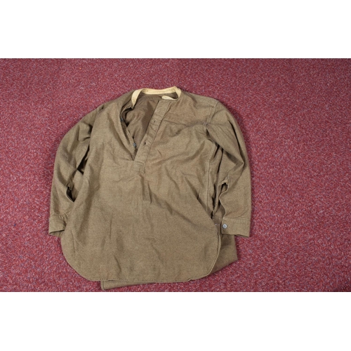 323 - EIGHT ITEMS OF MILITARY CLOTHING, to include WWII dated trousers, this lot includes a pair of 1943 s... 