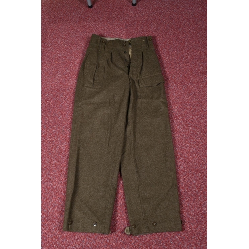 323 - EIGHT ITEMS OF MILITARY CLOTHING, to include WWII dated trousers, this lot includes a pair of 1943 s... 