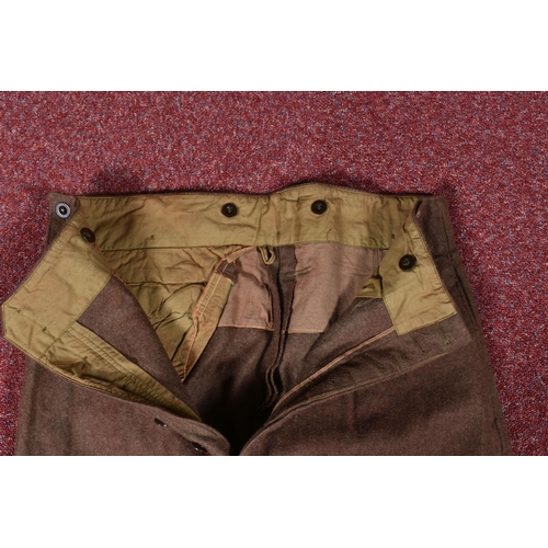 323 - EIGHT ITEMS OF MILITARY CLOTHING, to include WWII dated trousers, this lot includes a pair of 1943 s... 