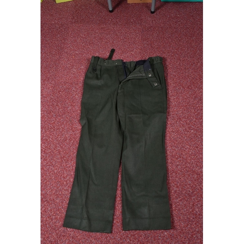 323 - EIGHT ITEMS OF MILITARY CLOTHING, to include WWII dated trousers, this lot includes a pair of 1943 s... 