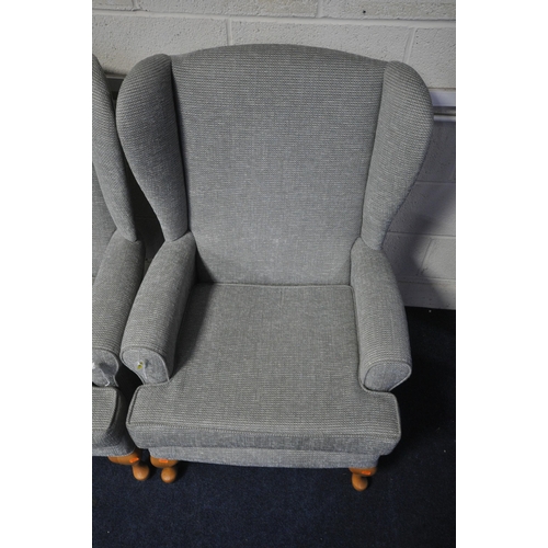 1395 - A PAIR OF GREY UPHOLSTERED WING BACK ARMCHAIRS, on beech legs (2)