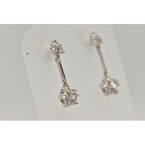 121 - A PAIR OF 18CT WHITE GOLD DIAMOND DROP EARRINGS, each earring designed with a diamond set flower dro... 