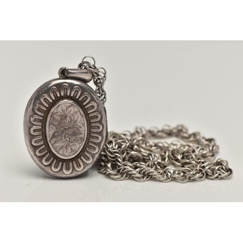 141 - A LATE VICTORIAN SILVER LOCKET, oval form etched floral centre with embossed detail surround, fitted... 