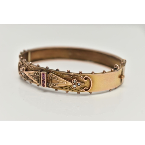 147 - A LATE VICTORIAN GEM SET HINGED BANGLE, the front half designed as a central vertical line of circul... 