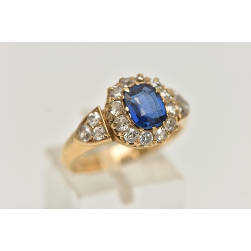 174 - A YELLOW METAL SAPPHIRE AND DIAMOND CLUSTER RING, centring on a cushion cut blue sapphire, measuring... 