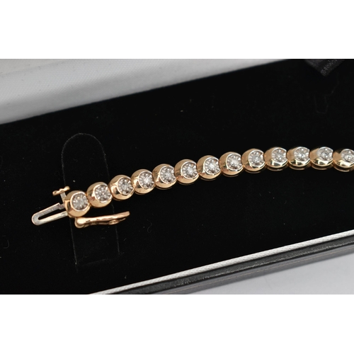 177 - A 9CT GOLD DIAMOND LINE BRACELET, designed as a series of circular links each set with a small round... 