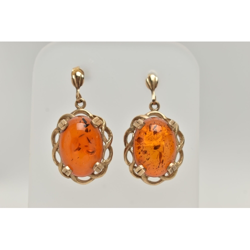 188 - A PAIR OF COPAL AMBER EARRINGS AND A PENDANT, oval cabochon copal amber set in an open work yellow m... 