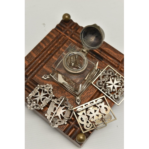 241 - AN INKWELL AND TWO NURSES BELT BUCKLES, a glass and white metal inkwell together with an oak, white ... 