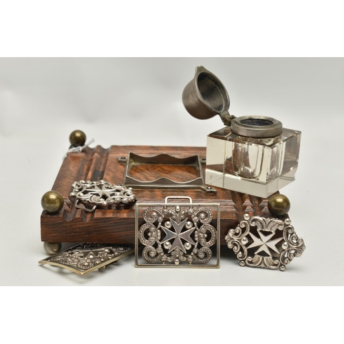 241 - AN INKWELL AND TWO NURSES BELT BUCKLES, a glass and white metal inkwell together with an oak, white ... 