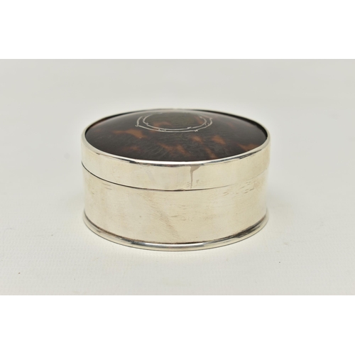 244 - AN EARLY 20TH CENTURY SILVER AND TORTOISESHELL TRINKET BOX, of circular outline with gilded interior... 