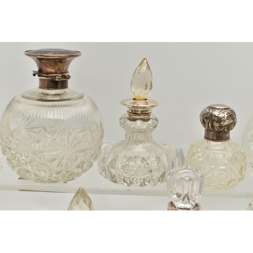 251 - FOURTEEN LATE 19TH AND EARLY 20TH CENTURY SILVER MOUNTED SCENT BOTTLES, various shapes and sizes inc... 