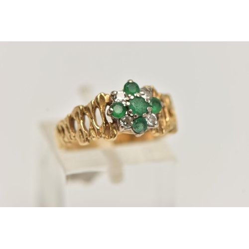 258 - A YELLOW METAL GEM SET CLUSTER RING, flower cluster set with circular cut emeralds and diamonds, tex... 