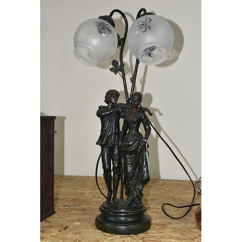 352 - A LARGE FIGURAL TABLE LAMP, featuring a couple, the male figure is playing a violin, two etched glas... 