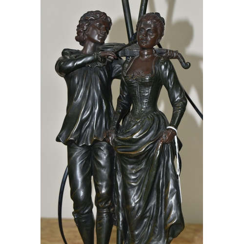 352 - A LARGE FIGURAL TABLE LAMP, featuring a couple, the male figure is playing a violin, two etched glas... 