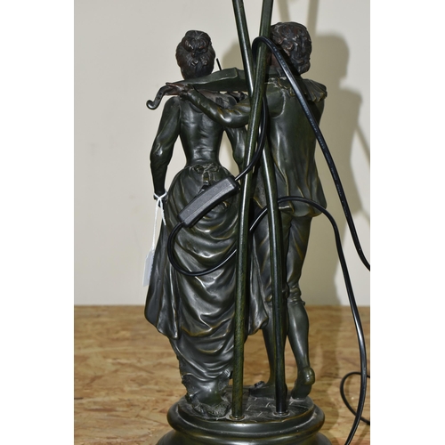 352 - A LARGE FIGURAL TABLE LAMP, featuring a couple, the male figure is playing a violin, two etched glas... 