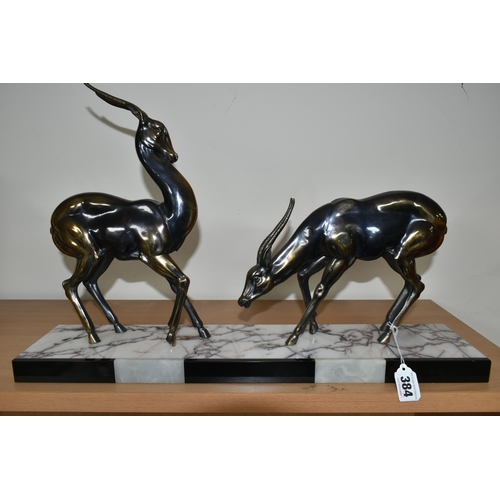 384 - AN ART DECO SCULPTURE OF A PAIR OF GAZELLES, in bronzed finish, on a three coloured marble plinth, h... 