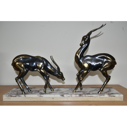 384 - AN ART DECO SCULPTURE OF A PAIR OF GAZELLES, in bronzed finish, on a three coloured marble plinth, h... 