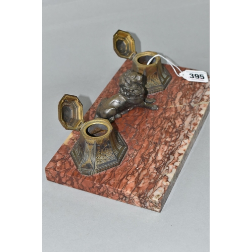 395 - A ROUGE MARBLE INK STAND FEATURING A LION, the twin inkwells and cast lion surmount a red marble bas... 